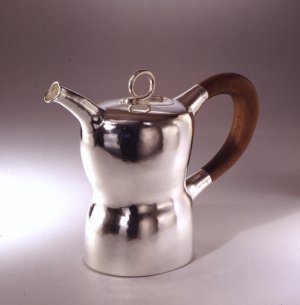 Silver pot in organic form with handle of cocobola